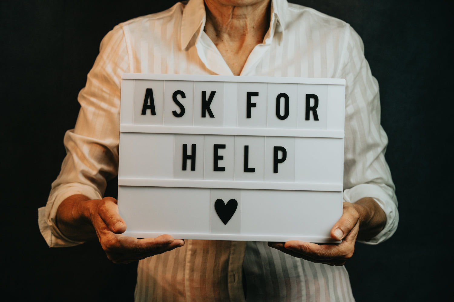 person-holds-a-sign-that-says-ask-for-help